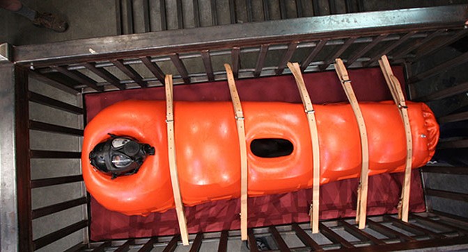 Orange inflatable rubber sleepsack bondage with gasmask