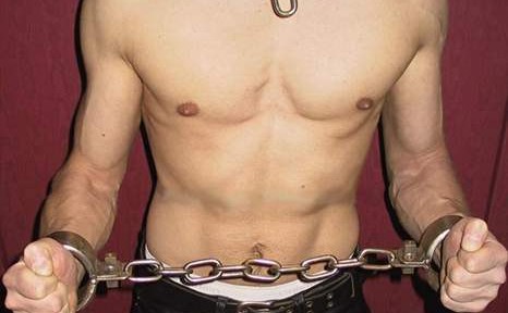 Men locked in heavy metal restraints