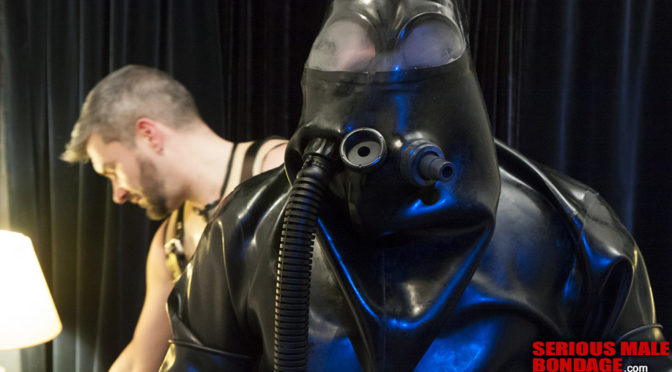 Bound in a heavy rubber suit