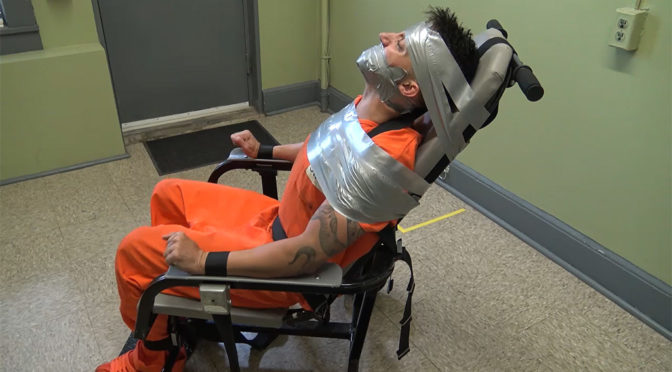 Cody gets strapped into a restraint chair and gagged with duct tape