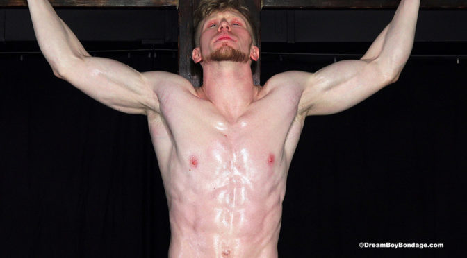 Jesse is hung from the bondage cross and whipped