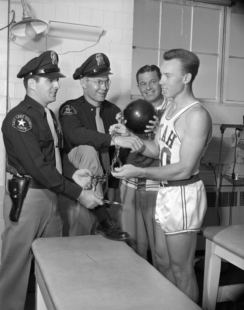 basketball player and handcuffs and cops