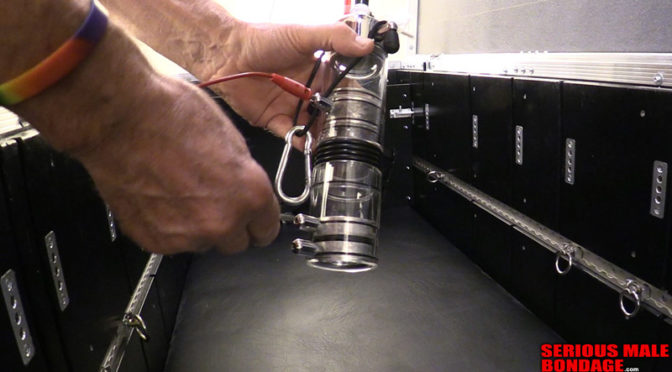 A captive gets pleasured with a milking machine while locked in a bondage box