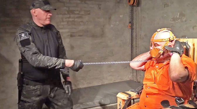Corrections officer harasses an inmate who is bound in fetish gear
