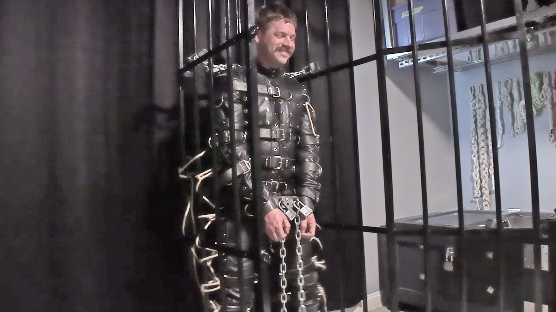 Lukas Tyler in a Leather Bondage Suit and Standing Cage
