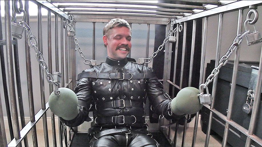 Lukas Tyler in a Leather Bondage Suit and Puppy Cage