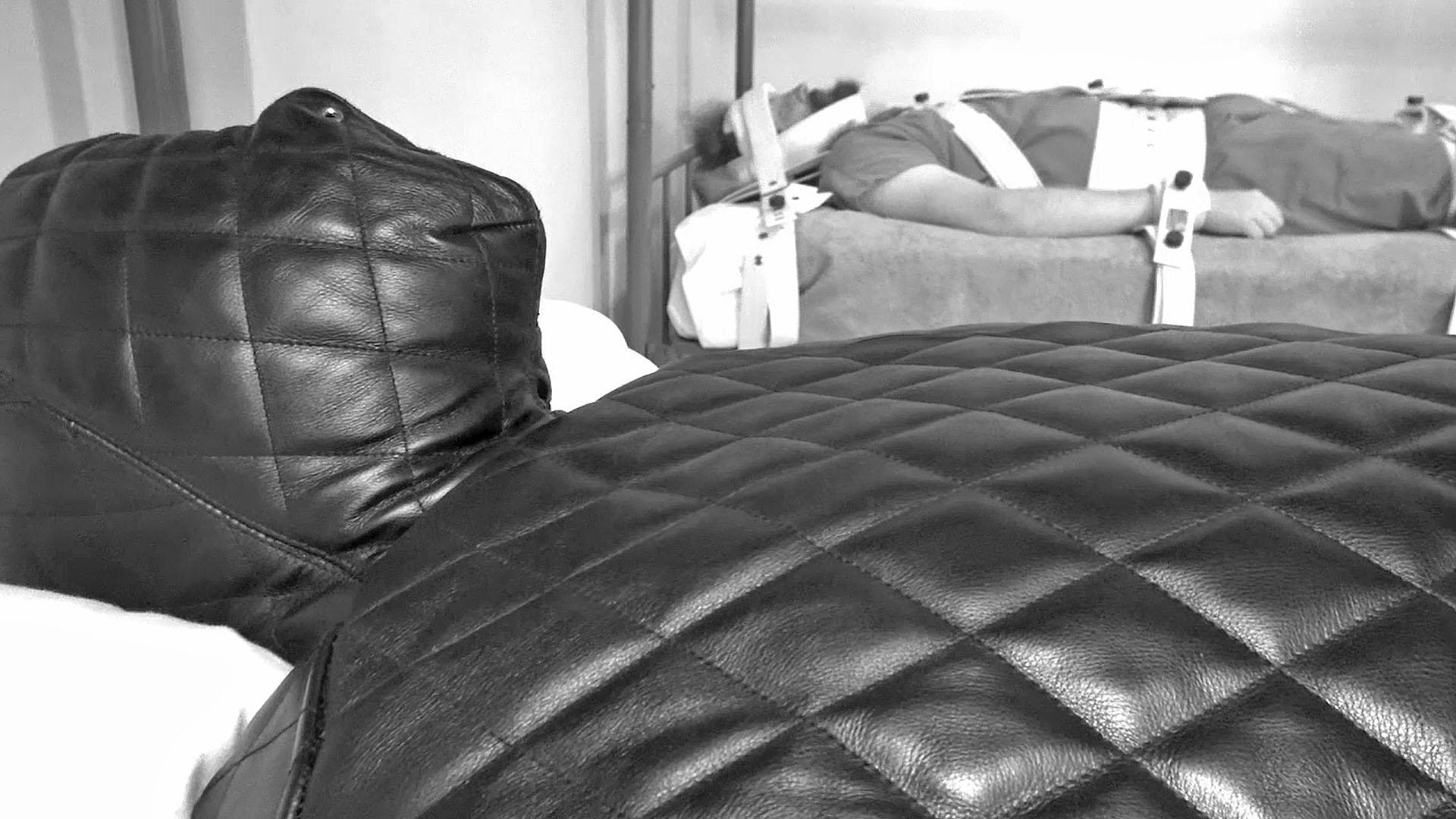 man in leather isolation bondage suit no eyes