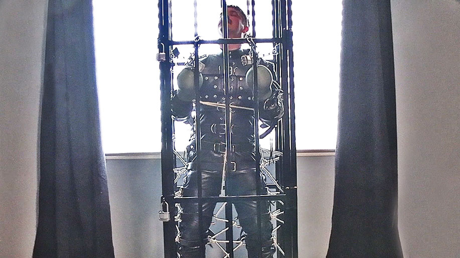 Lukas Tyler in a Leather Bondage Suit and Standing Cage