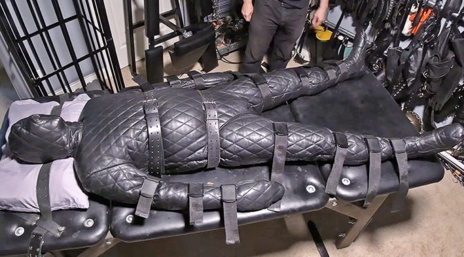 Bound to the Bondage Table in a Leather Prison Suit
